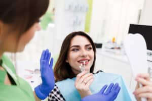 woman in the dentist chair is choosing out the colour of her new dental veneers