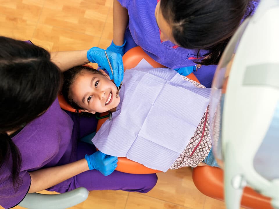 young girl in the dentists chair for her back to school checkup