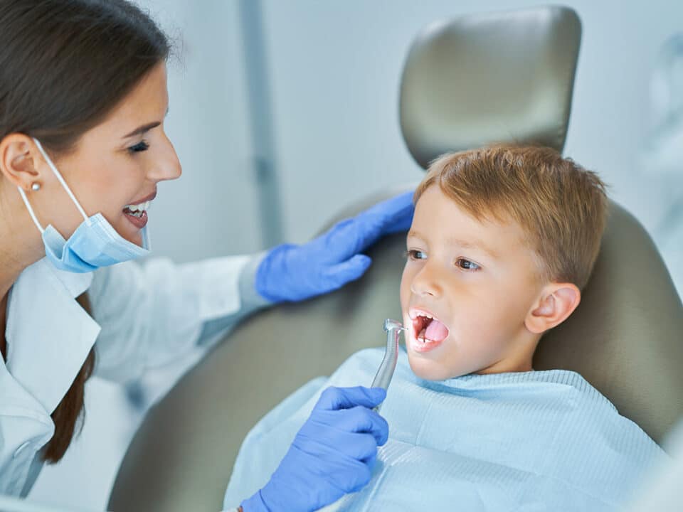 young boy is at the dentist for his back to school dental checkup