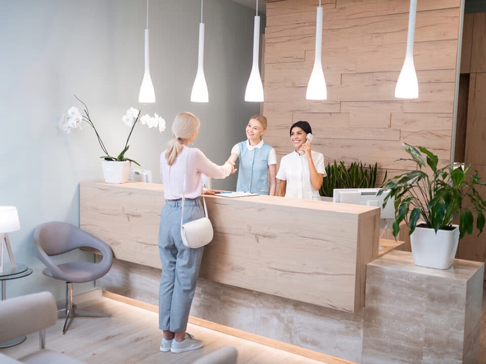 woman at the reception desk of her new dental office