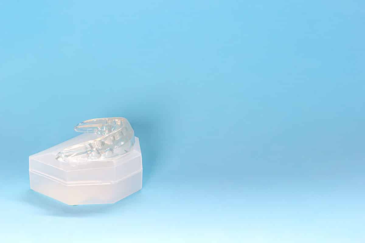 photo of a mouth guard against a blue backdrop