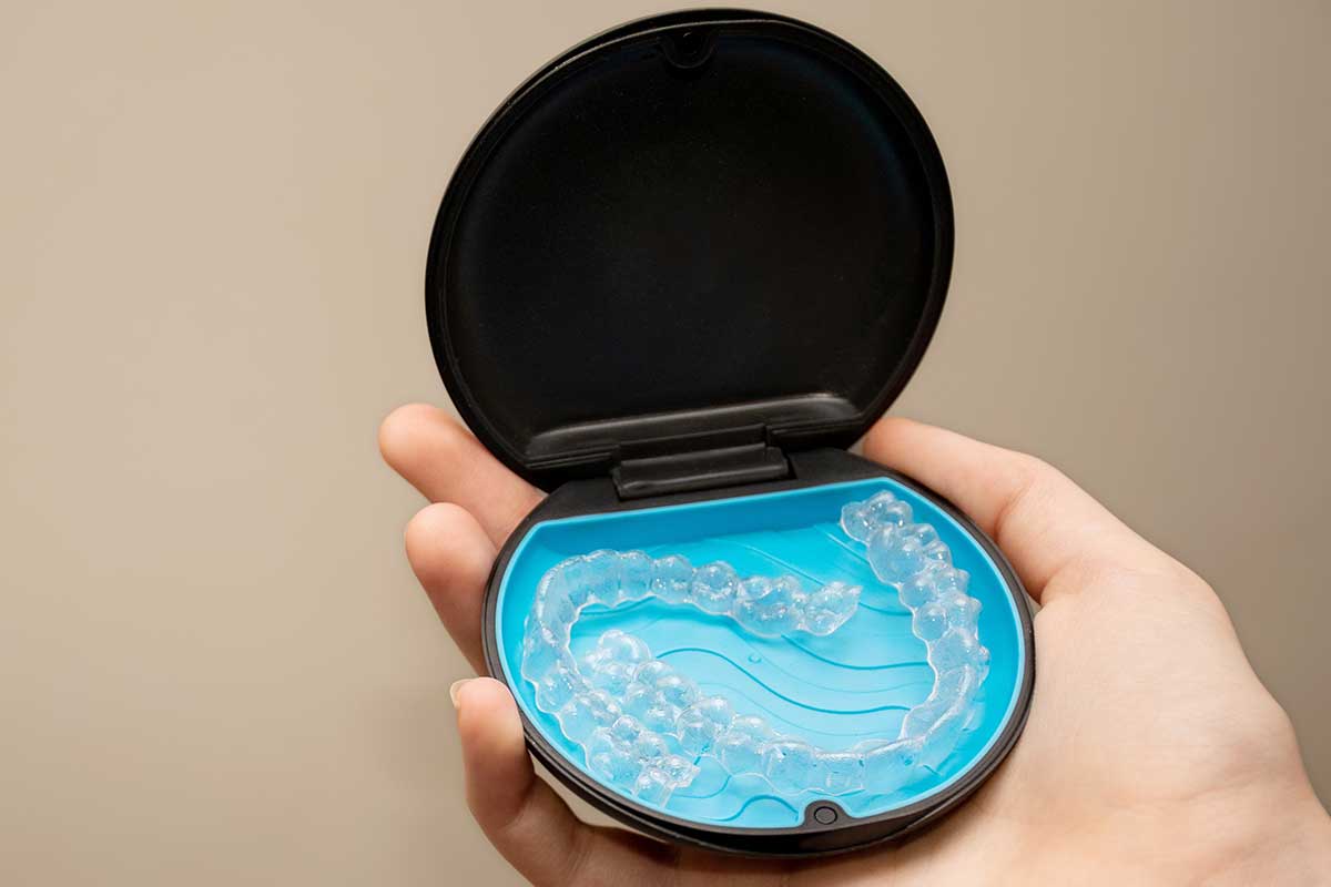 an image showing a set of clear aligners Invisalign in their carrying case