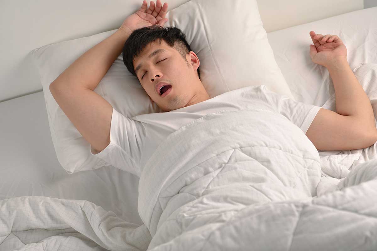 asian man sleeping and snoring like a bear due to sleep apnea