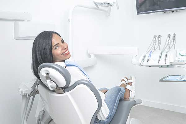 woman sits in the dentist chair at her local Burlington dentist office