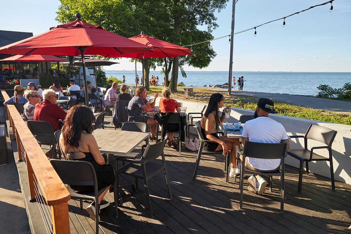 people sitting on a restaurant patio on the Hamilton shores of lake Ontario