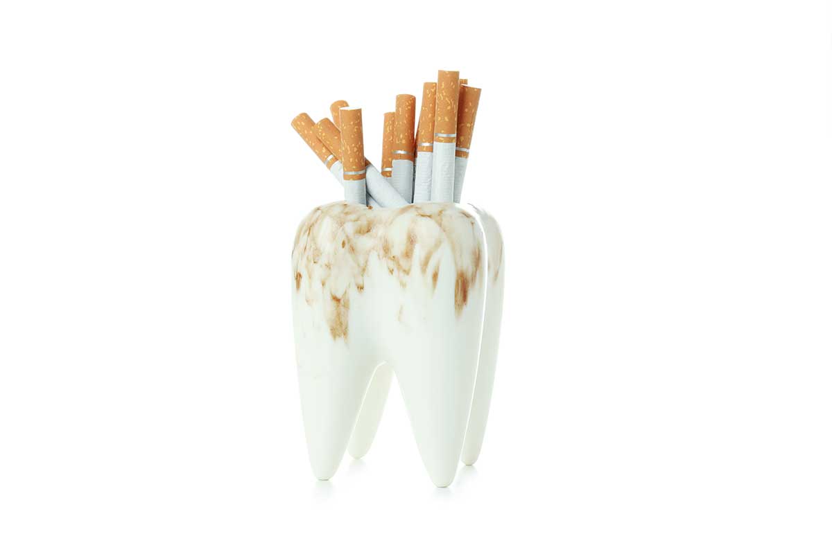 a model of a stained tooth being used as an ashtray