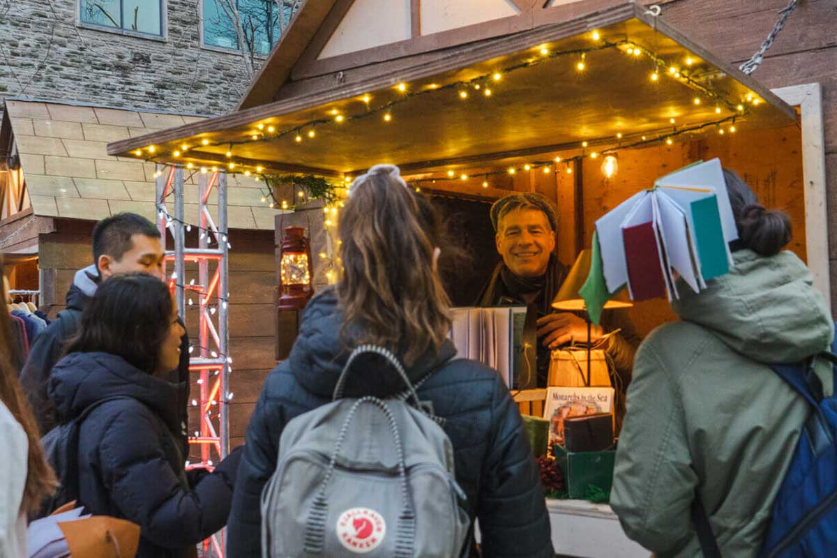 photo of a vendor and his booth at one of the hamilton christmas markets