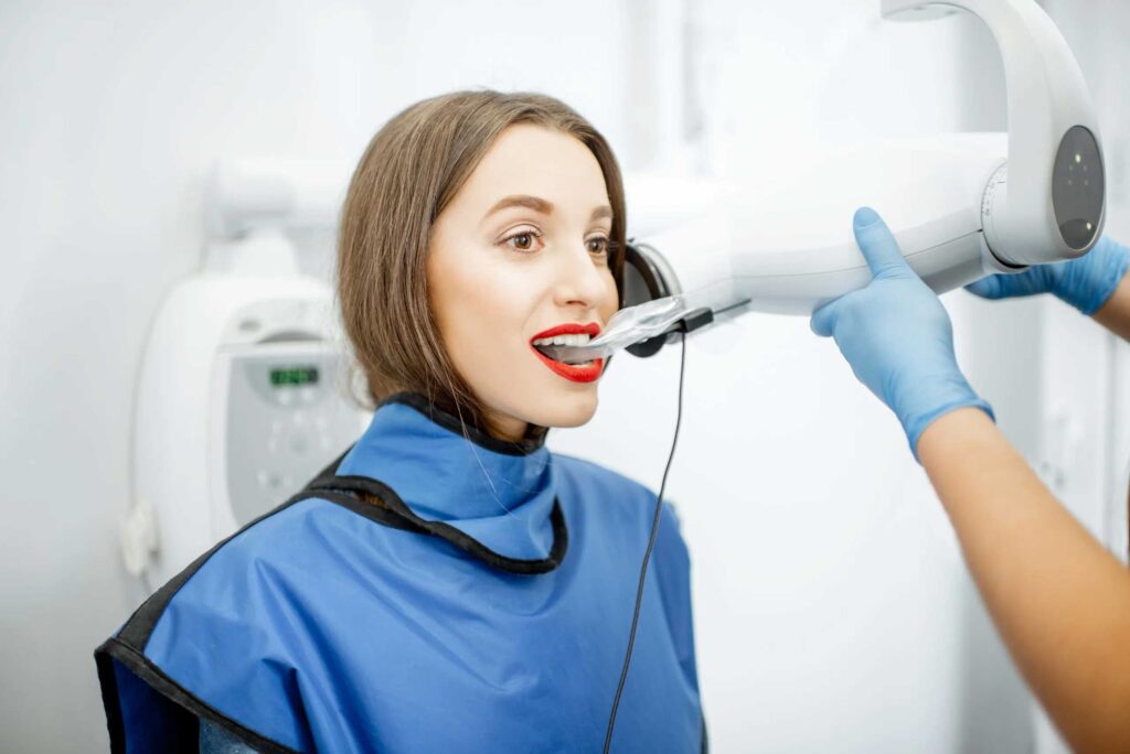 woman with lead vests on making sure the dental x-ray is safe