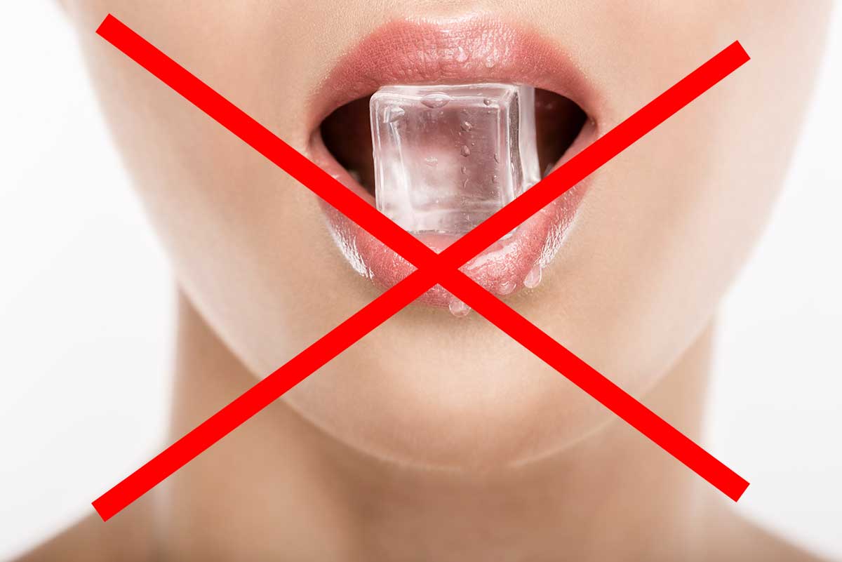 woman demonstrates chewing on ice as something not to do when taking care of dental fillings