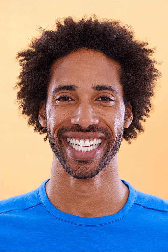 man shows off his perfect smile thanks to dental bonding