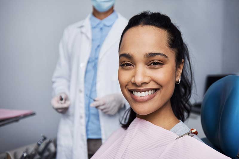 woman shows off her smile after dental bonding at martindale dental