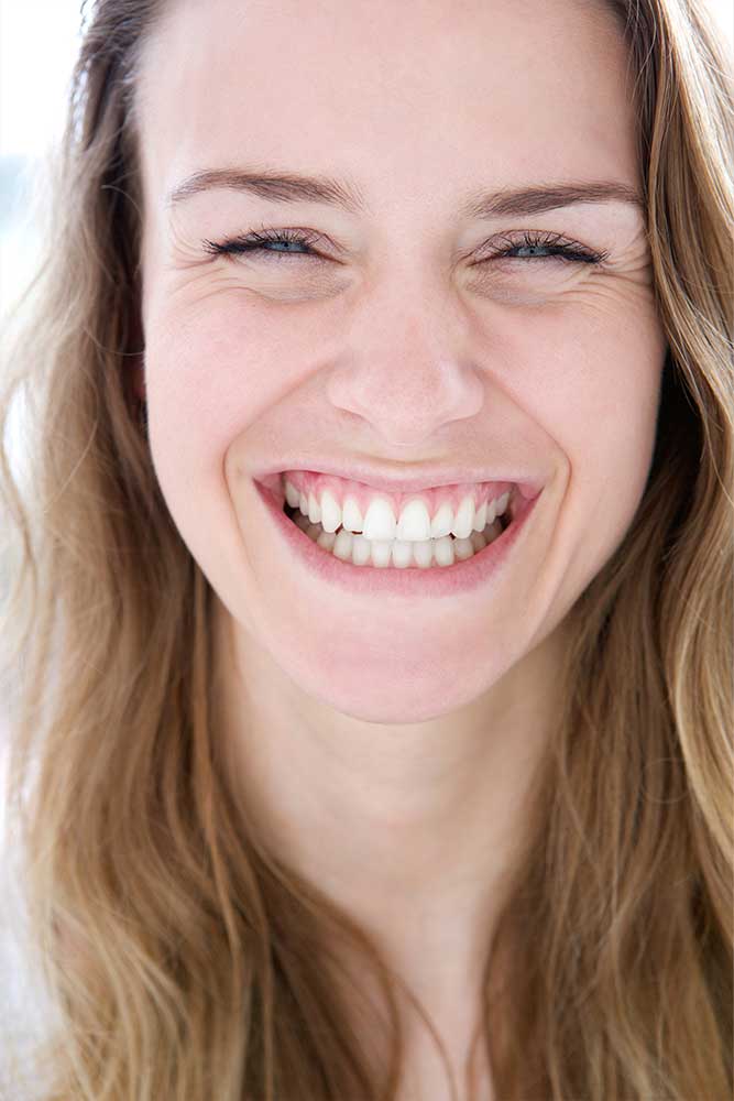 woman smiling after successful oral surgery at martindale dental in hamilton