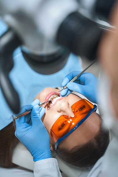 woman in the dentists chair undergoing the steps of the reconstructive surgery process