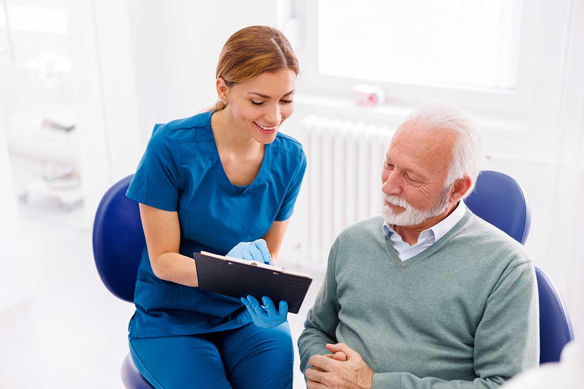 dentist explains services that are covered under CDCP to one of her patients