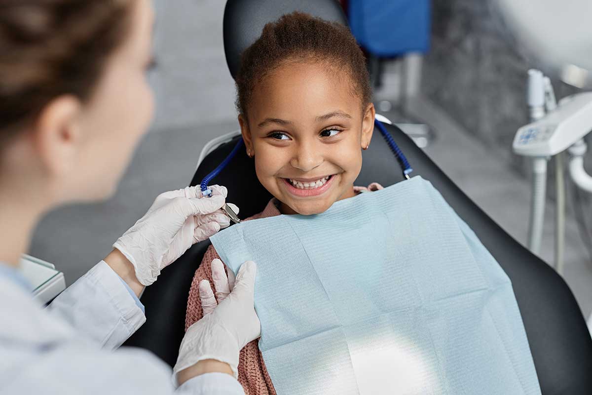 happy young girl smiles while getting a CDCP covered dental treatment