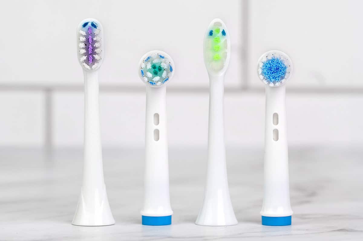 four electric toothbrush heads standing vertically