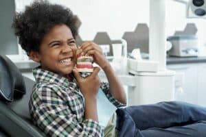 young child in the orthodontists chair getting checked out because his mom thinks she sees signs your child needs braces