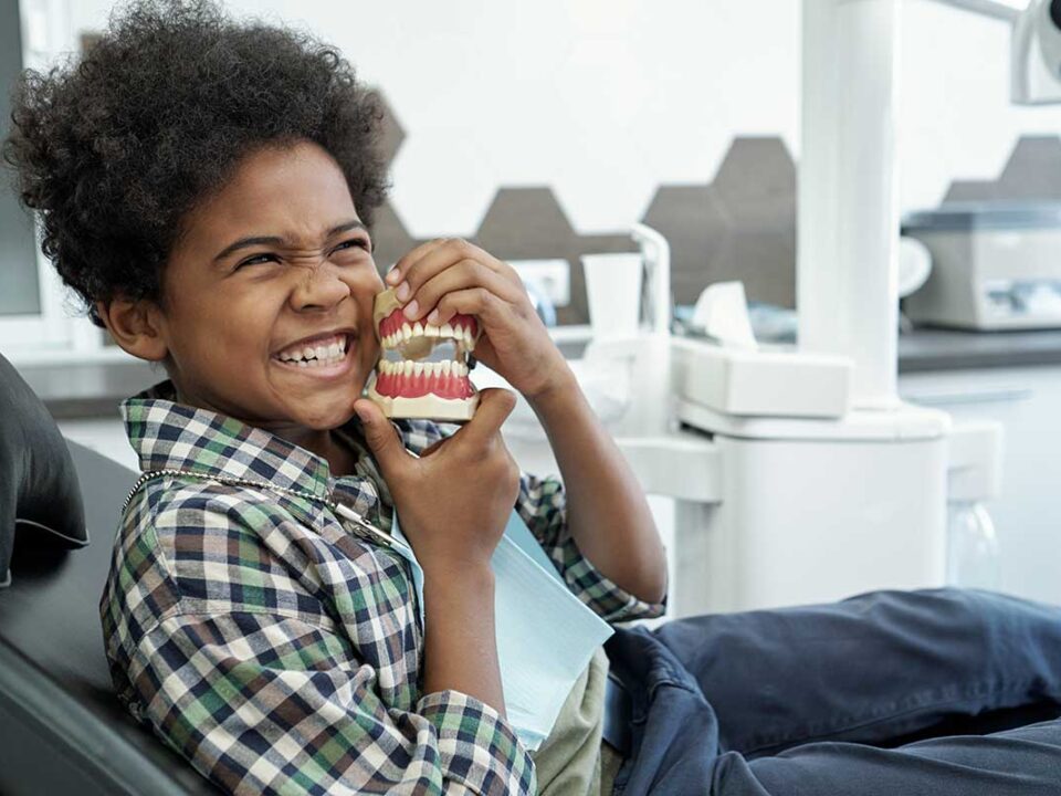 young child in the orthodontists chair getting checked out because his mom thinks she sees signs your child needs braces