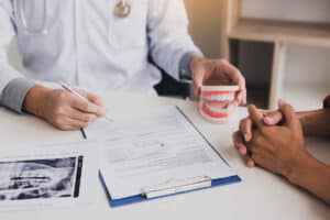 dentist sitting with patient at a desk Navigating the CDCP Claim Process