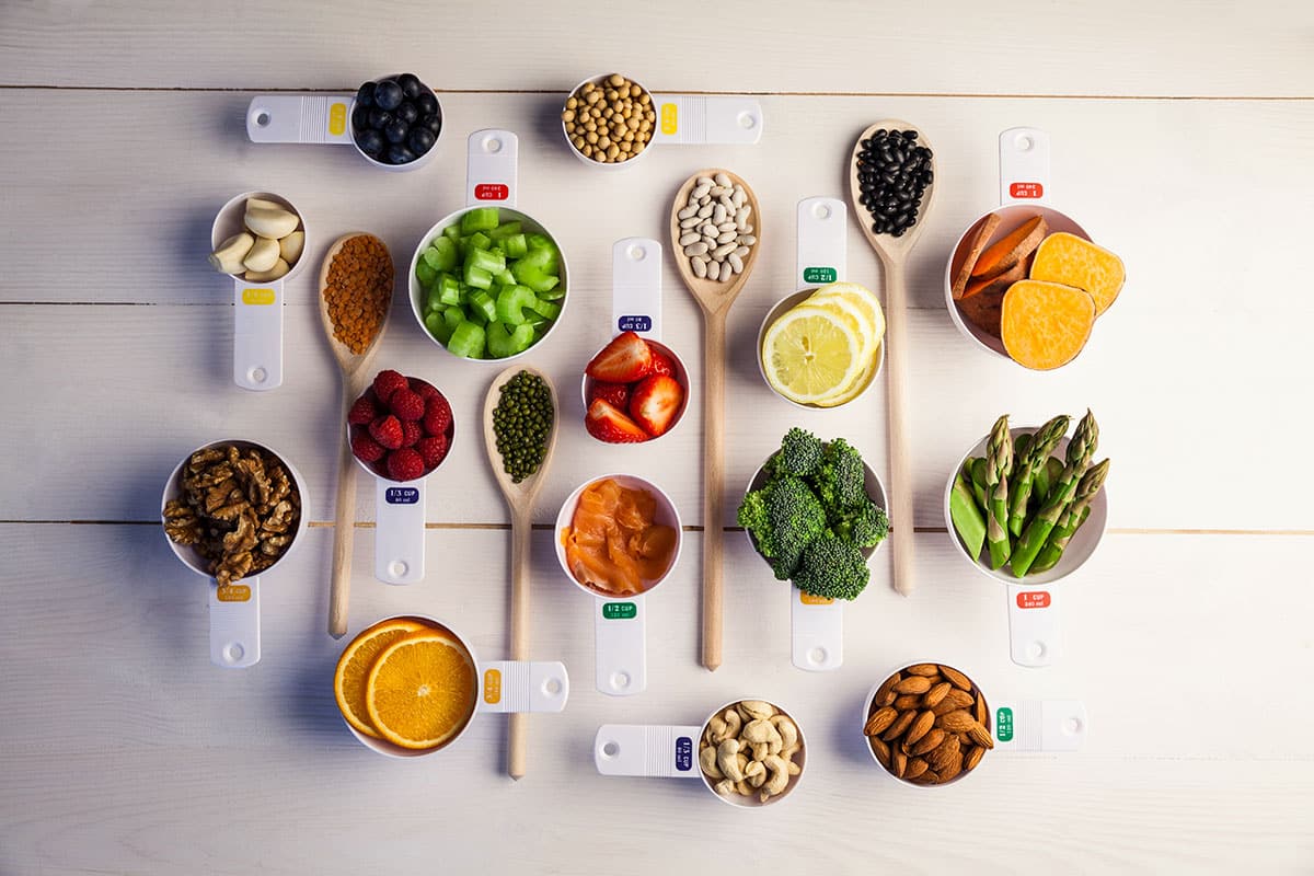 table with a lot of healthy foods in small portions spread out on it