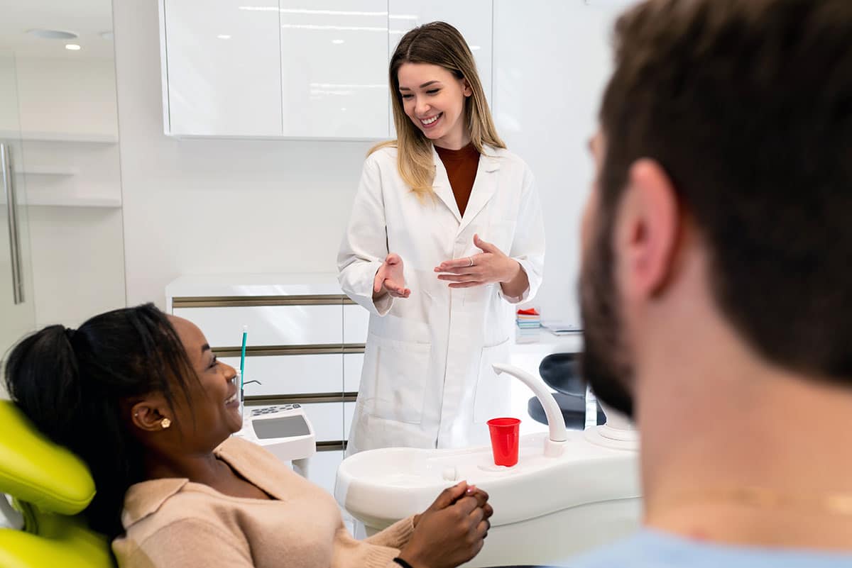 female dentist speaks to a patient who is also a diabetic about her tailored treatment approach