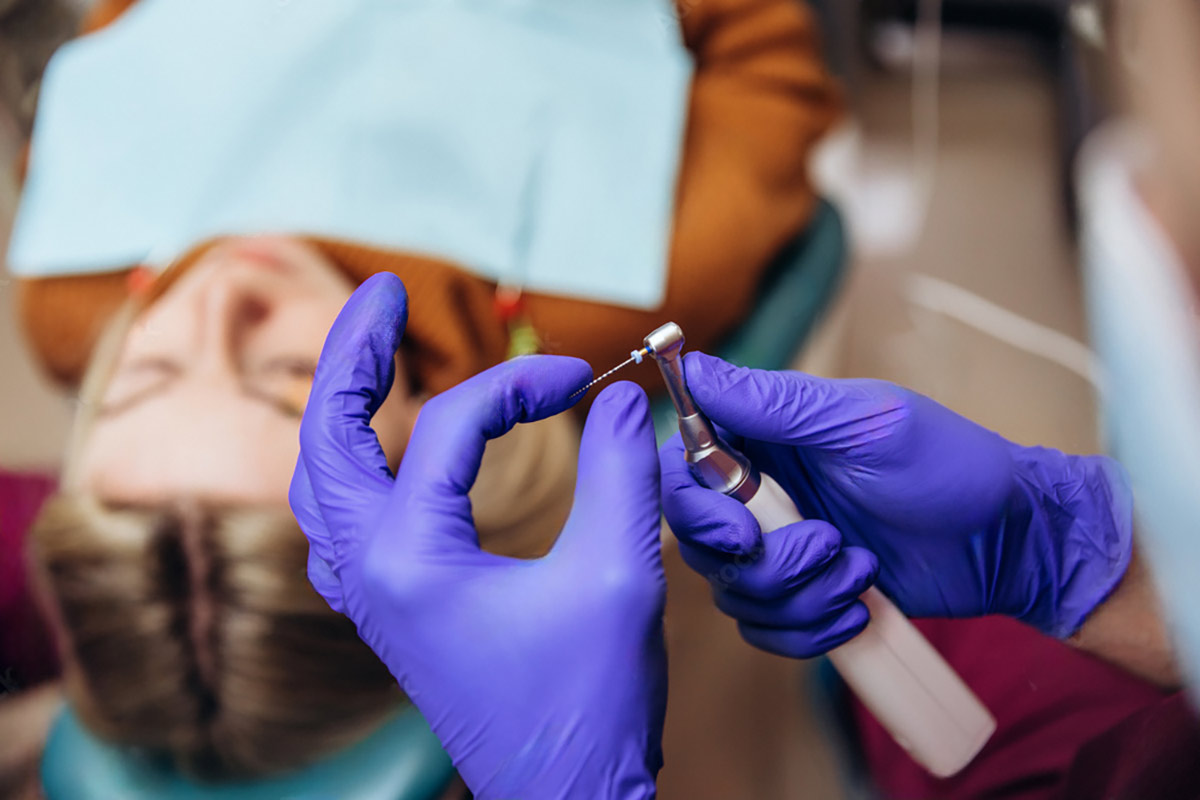 dentist prepares to work on a patient who needs a root canal treatment