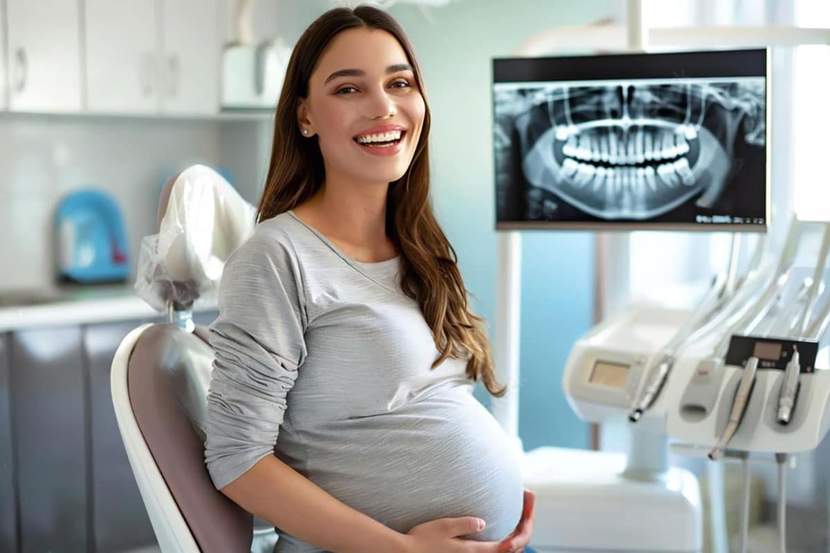 pregnant woman smiles after having successful pregnancy safe dental xrays taken
