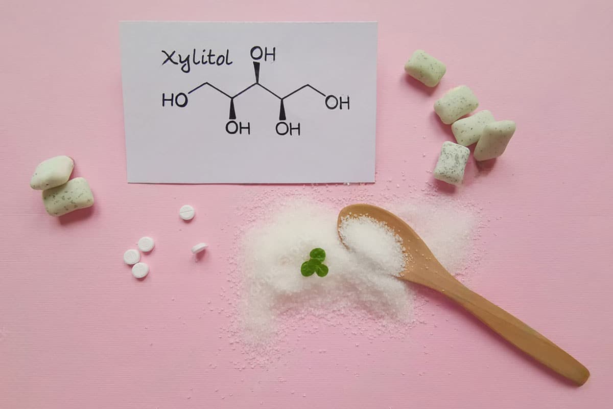 a sample, a wooden spoon and the chemical formula for one of the most popular sugar substitutes - xylitol