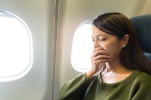 can i fly after dental work or surgery is a question this woman should have asked before travelling as she sits in the plane holding her mouth in pain