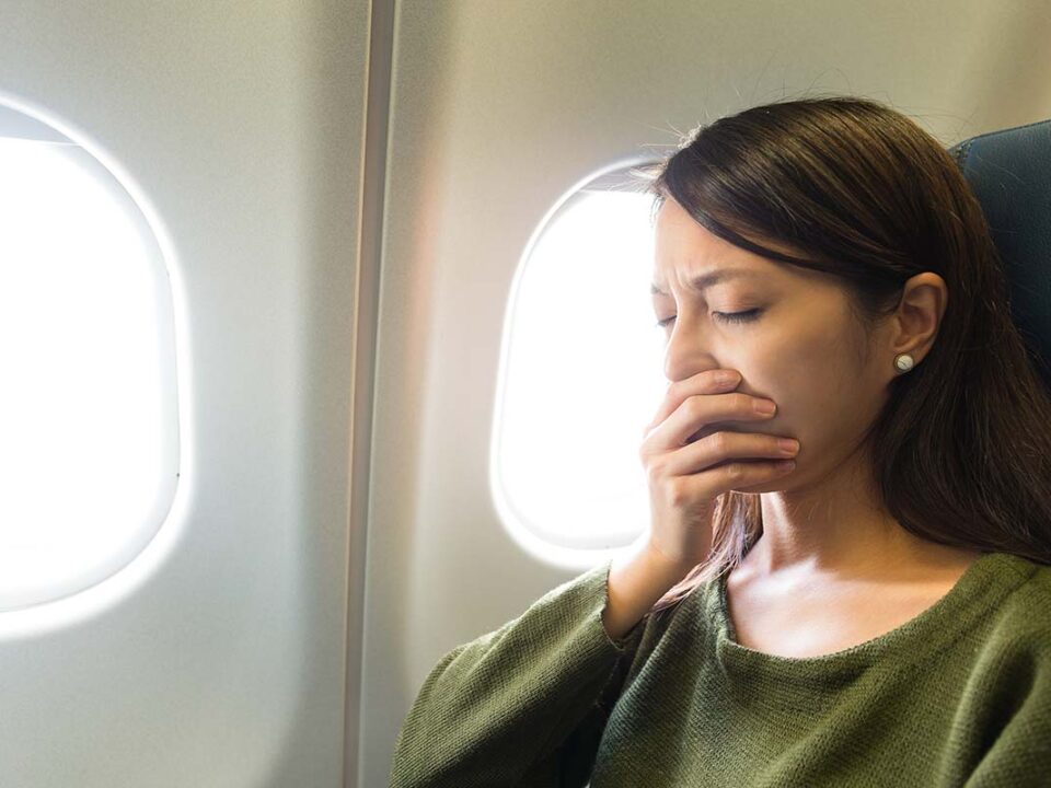 can i fly after dental work or surgery is a question this woman should have asked before travelling as she sits in the plane holding her mouth in pain