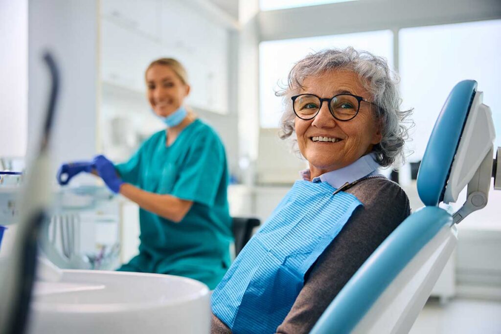 senior at the dentist asking does odsp cover dentures because she has some missing teeth that need to be replaced.