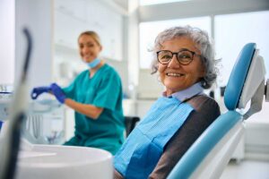 senior at the dentist asking does odsp cover dentures because she has some missing teeth that need to be replaced.