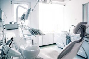 image showing an empty dentist chair in the office because dentist is busy explaining what does odsp cover to a patient.