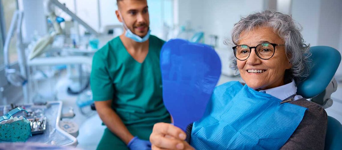 Elderly woman smiling because she had asked how much does dental care cost with CDCP so she knows that she's fully covered for her treatment