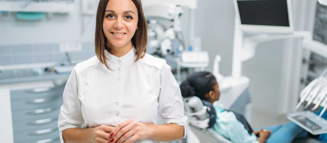 female dentist helping her patient understand what services are covered under the cdcp in Ontario