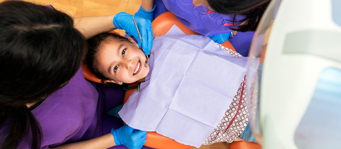 young girl in the dentists chair for her back to school checkup