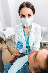 dentist performs a dental exam and cleaning appointment on her patient