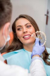 woman smiles as she picks the shape and colour of her dental implants