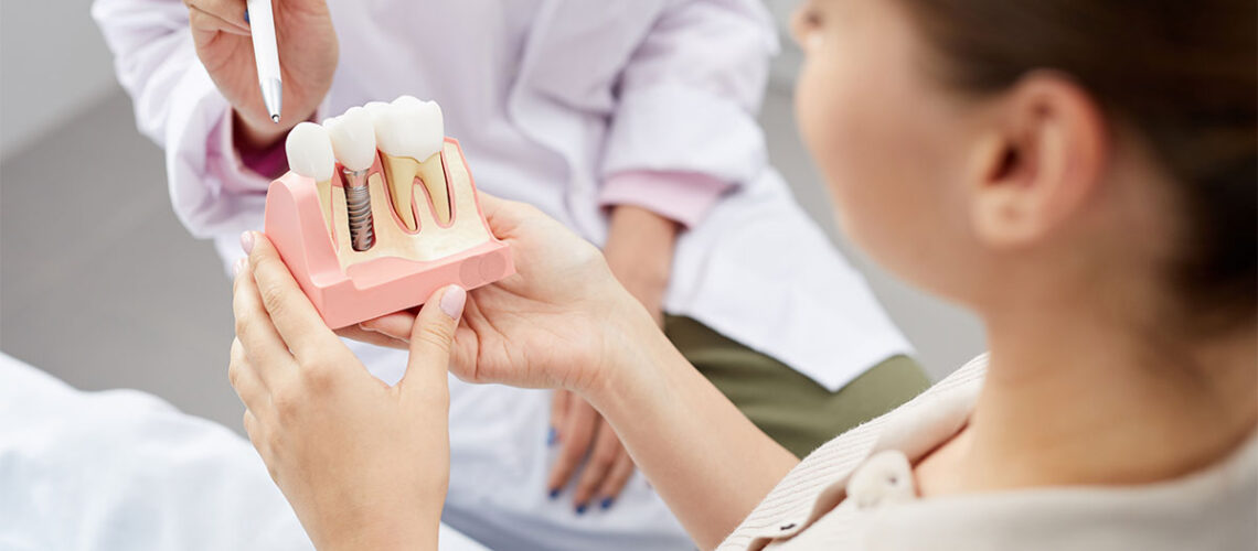 image of a dentist teaching a patient about dental implants, telling her dental implants what you really need to know