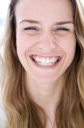 woman smiling after successful oral surgery at martindale dental in hamilton