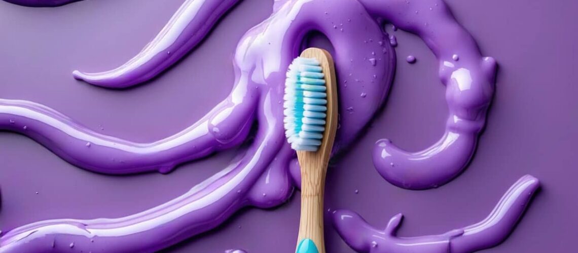 image showing purple toothpaste on a purple background with a blue toothbrush as the featured image for an article comparing pap+ and purple toothpaste as peroxide whitening alternatives