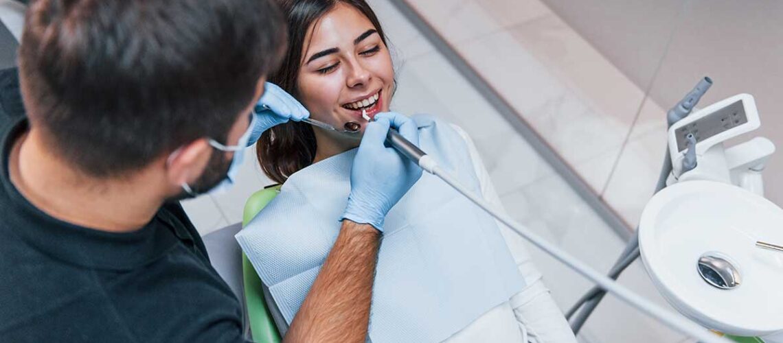 woman getting a dental cleaning and checkup as part of her preventative dentistry program