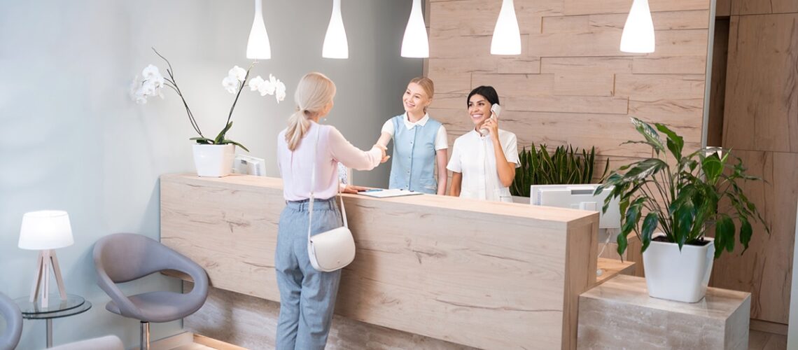 woman at the reception desk of her new dental office